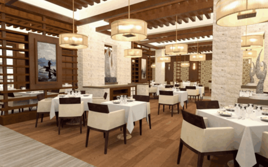 Formal dining room with wine wall and white table linens.